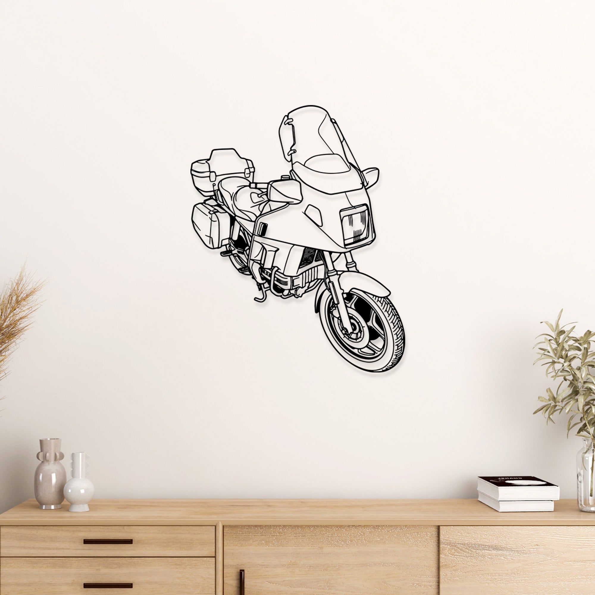 Black metal BMW K100LT motorcycle wall art on a white wall.
