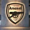 Black metal Arsenal FC logo wall art with bright LED backlight.