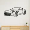 Black metal Aston Martin DBS Superleggera wall art on a white wall.