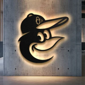 Black metal Baltimore Orioles logo wall art with bright LED backlight on a concrete wall.