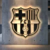 Black metal Barcelona FC crest wall art with warm LED backlighting.