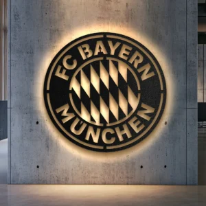 Black metal Bayern München logo wall art with golden accents.