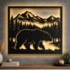 A large rustic metal wall art featuring a bear and mountain silhouette with LED backlighting.