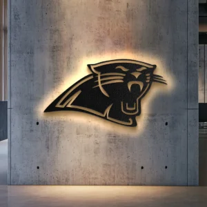 Black metal Carolina Panthers logo wall art with golden backlight.
