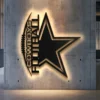 Black metal Dallas Cowboys football star logo wall art with bright LED backlight.