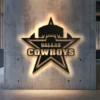 Black metal Dallas Cowboys star logo wall art with bright LED backlight.