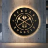 Black metal Denver Nuggets logo wall art with golden accents.