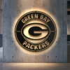 Green Bay Packers metal logo wall art with golden finish and LED backlight.