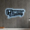 Black metal Honda Racing logo wall art with blue LED backlight.