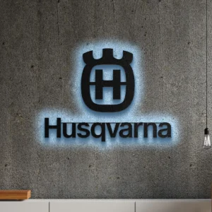 Black Husqvarna metal logo wall art with blue LED backlight on a concrete wall.