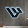 Black metal Livewire logo wall art with blue LED backlight on a concrete wall.