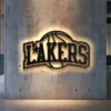 Black metal Los Angeles Lakers logo wall art with bright LED backlighting.