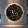 Milwaukee Brewers black metal logo wall art with golden accents.