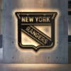 New York Rangers metal wall art with LED backlight on a concrete wall.