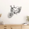 Black metal Peugeot 103 moped wall art on a white wall.