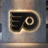 Black metal Philadelphia Flyers logo wall art with warm LED backlighting.