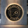 Philadelphia Flyers metal logo wall art with LED backlight on concrete wall.