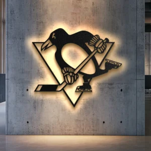 Black metal Pittsburgh Penguins logo wall art with warm LED backlighting on a concrete wall.