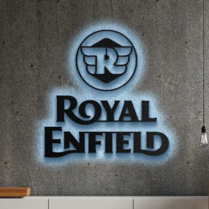 Black Royal Enfield metal logo wall art with blue LED backlight on a concrete wall.