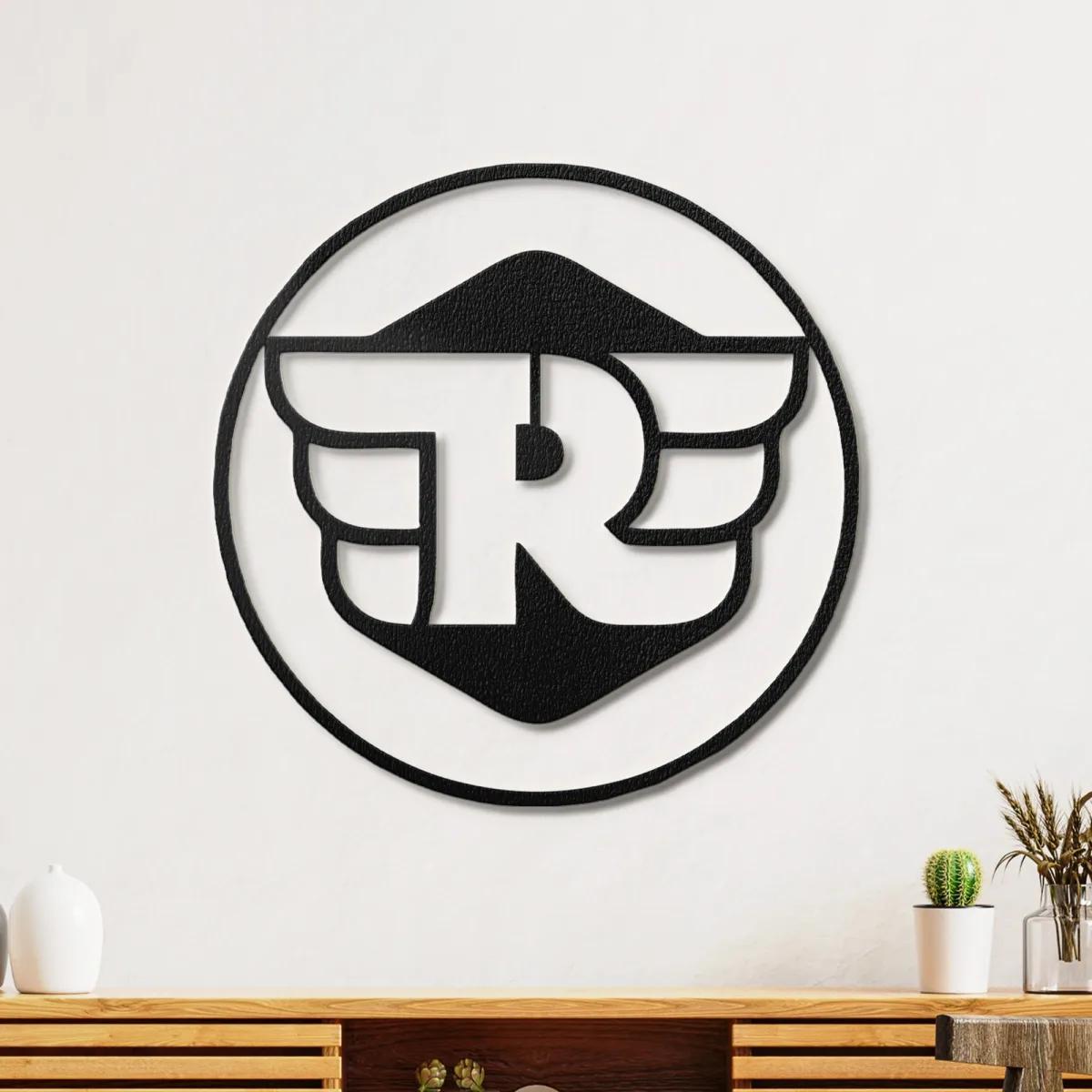 Close up of the Royal Enfield emblem showing texture and light glow