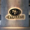 Black metal San Francisco 49ers logo wall art with bright LED backlighting.