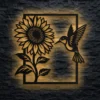 Oversized rustic sunflower and hummingbird metal wall art with warm LED backlighting.