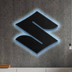 Black metal Suzuki logo wall art with blue LED backlight on concrete wall.