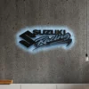 Black metal Suzuki Racing logo wall art with blue LED backlight