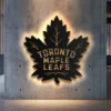 Black metal Toronto Maple Leafs logo wall art with bright LED backlighting.