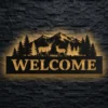 A large Welcome Deer Forest Scene metal sign with LED backlight on a dark brick wall.