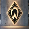 Black metal Werder Bremen football club logo wall art with LED backlighting.