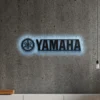 Black metal Yamaha logo wall art with blue LED backlight.