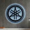 Black metal Yamaha logo wall art with blue LED backlight